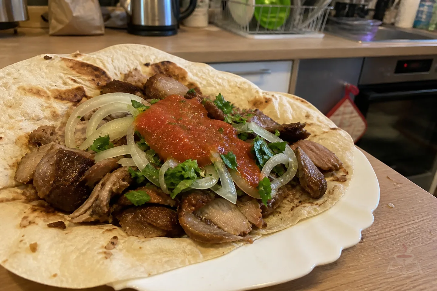 Armenian Karsi khorovats sliced lamb in lavash with herbs and tomato sauce