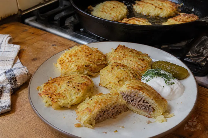 Belarusian kolduny potato cakes with beef filling, sour cream, and dill