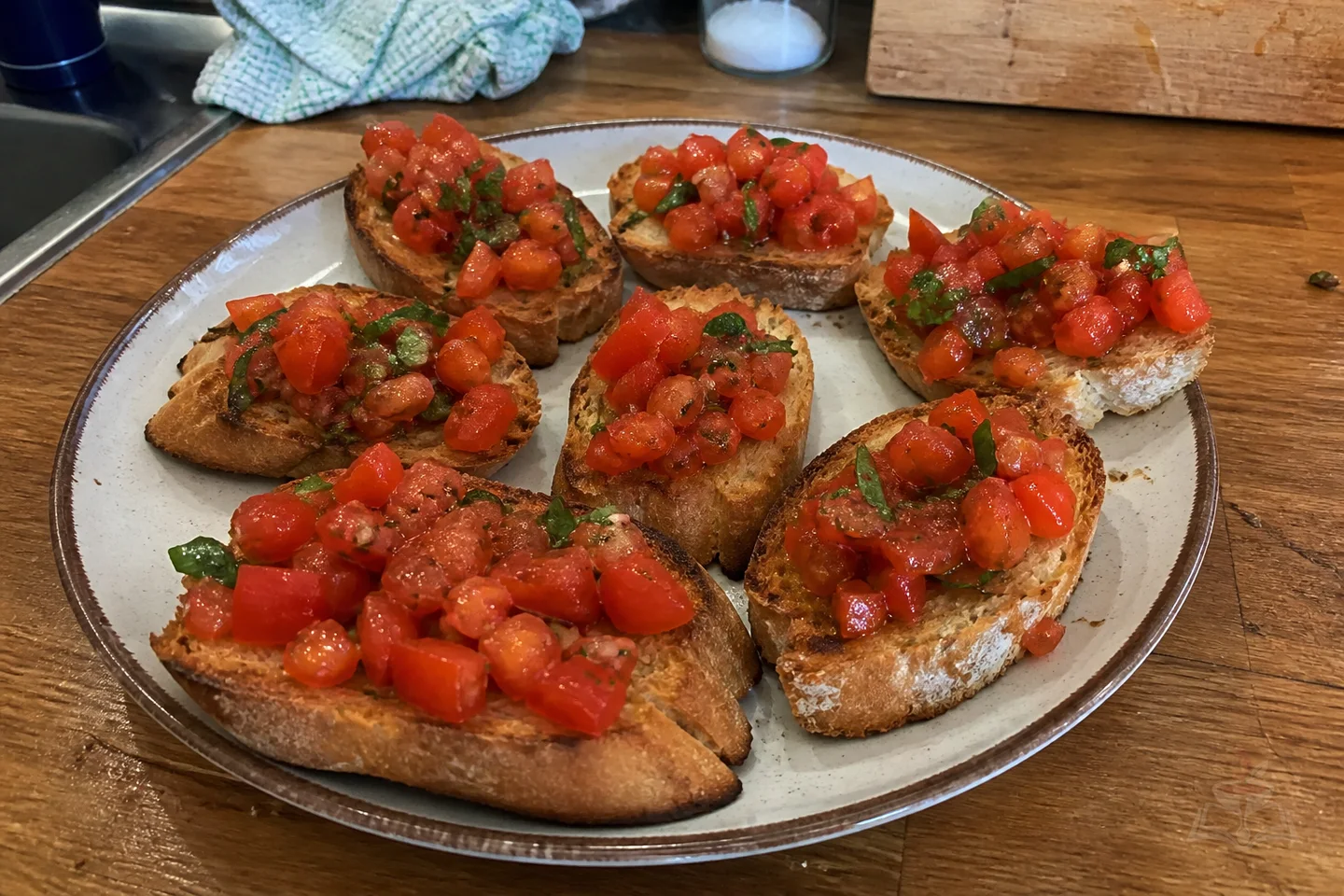 Eight Italian bruschetta toasts with tomatoes, basil, garlic, and olive oil