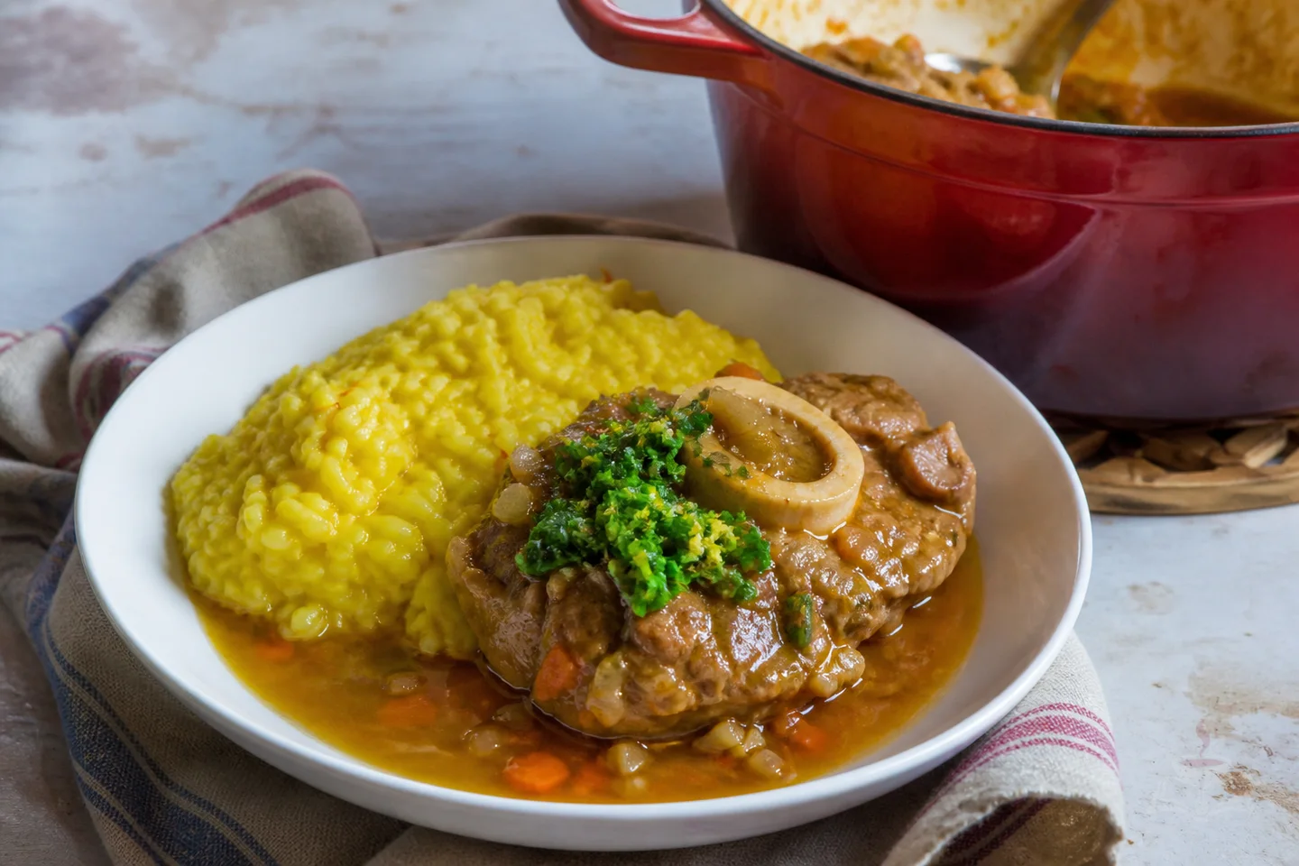 Milanese osso buco veal shank with golden sauce, gremolata, and risotto
