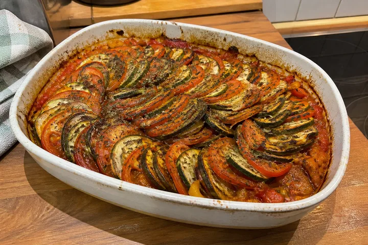 Baked ratatouille with tomatoes, eggplant, zucchini, and Provençal herbs