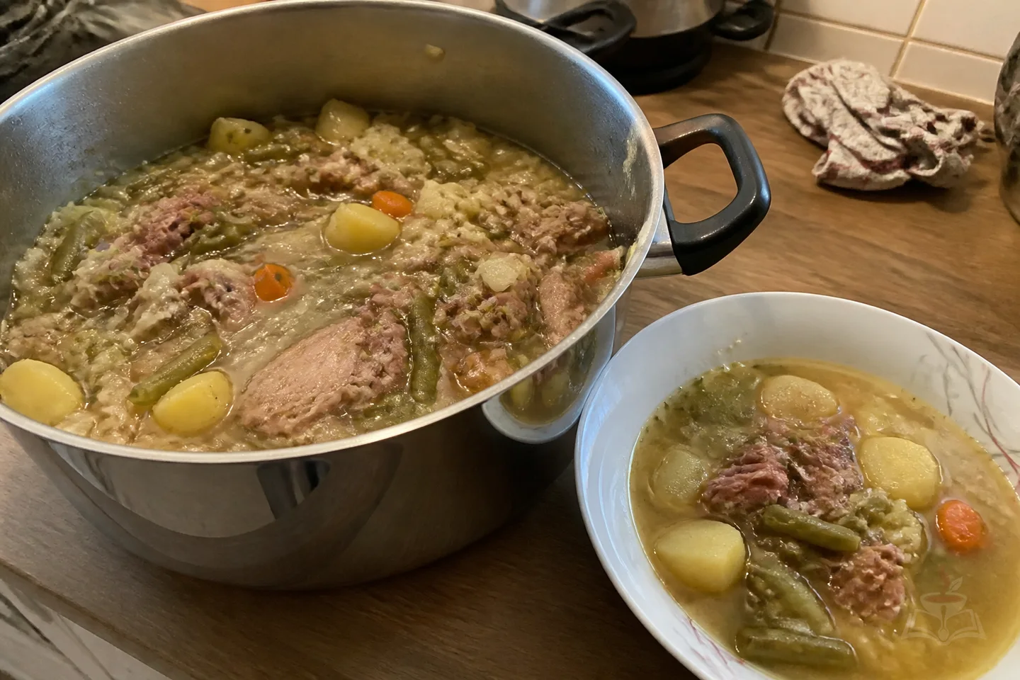 German Eintopf stew with smoked pork ribs, cabbage, potatoes, green beans, and carrots