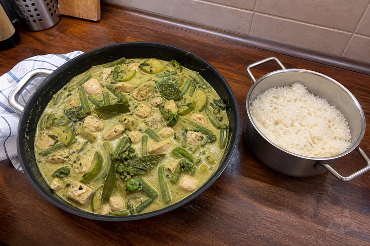 Thai green chicken curry with vegetables, basil, and rice
