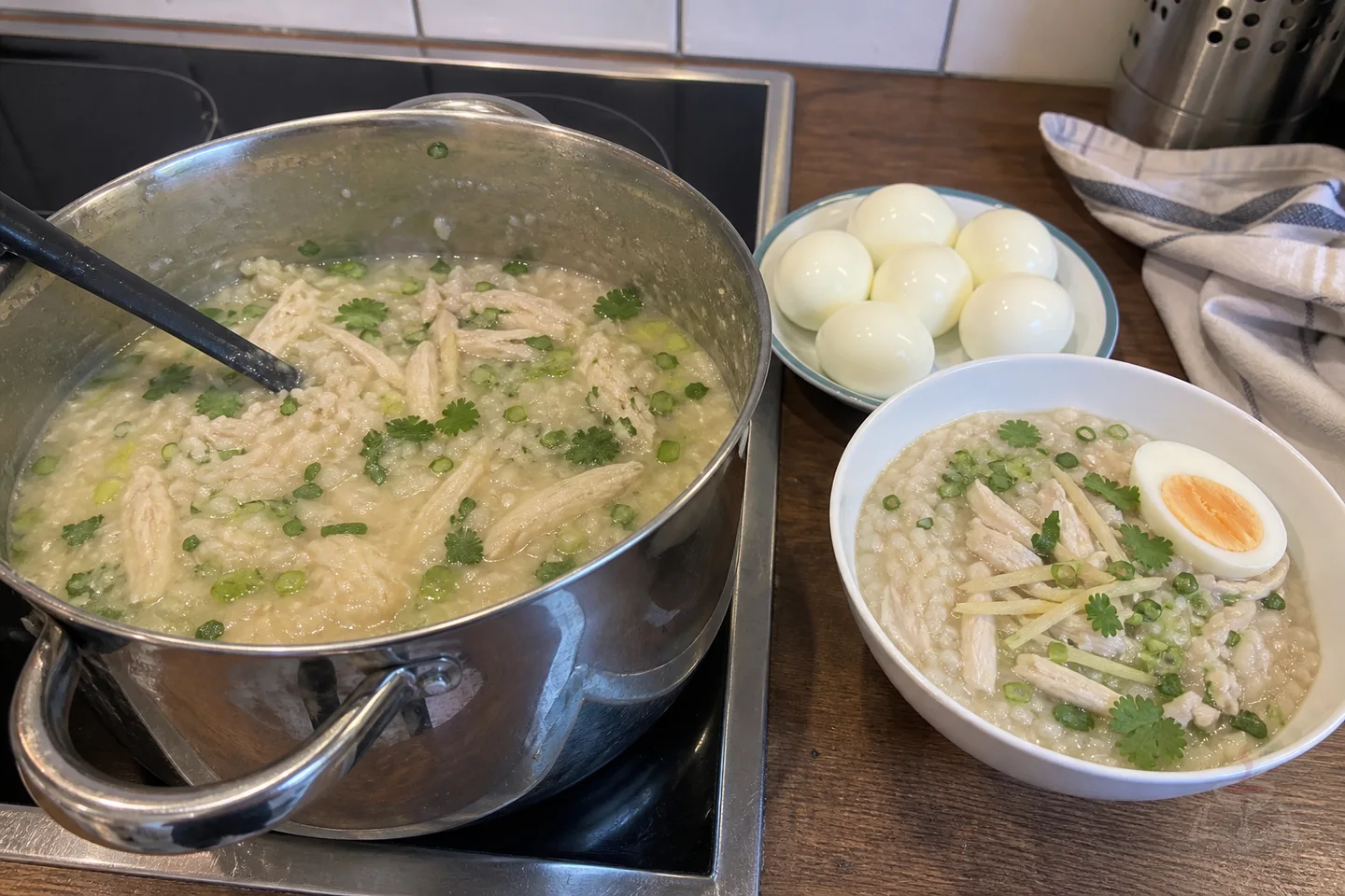 Thai jok rice porridge with sliced chicken, soft egg, ginger, scallions, and cilantro